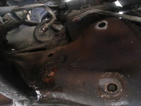 1994 Ford Bronco - Underside view of a vehicle's steering box and associated hydraulic lines.