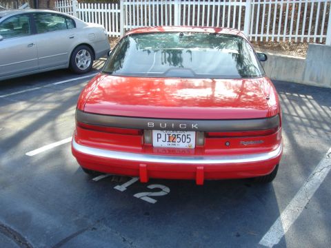 1980 Ford Mustang - Rear view of a red Buick Reatta with a Georgia license plate.