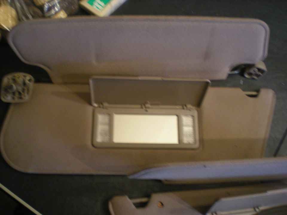 Tan interior sun visors with illuminated vanity mirrors