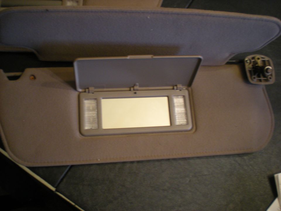 Car visor with vanity mirror and lights, another visor above
