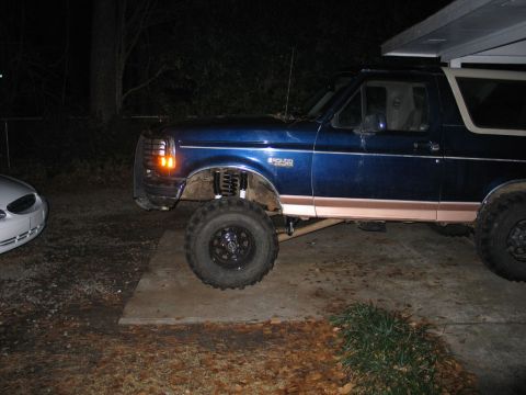 1995 Ford Bronco - Blue 1995 Ford Bronco with a lift kit installed, showing off its suspension and tires.