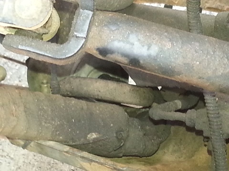 Close-up of suspension components, possibly a spring and metal brackets