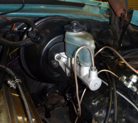 1964 Mercury Monterey - Close-up of a brake master cylinder and brake booster assembly, showing brake lines.