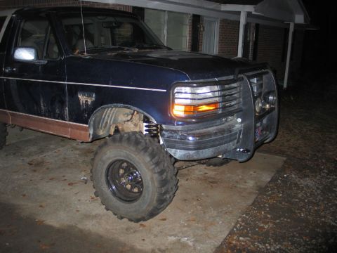 1995 Ford Bronco - Front 3/4 view of a lifted 1995 Ford Bronco with large off-road tires.