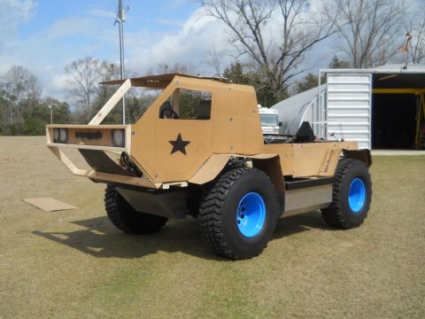 1992 Ford Bronco - This custom vehicle appears to be a homemade construction with a cardboard exterior and distinctive blue wheels.
