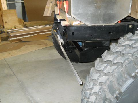 1992 Ford Bronco - Close-up of a vehicle's rear frame and tire, possibly undergoing modifications or repairs.