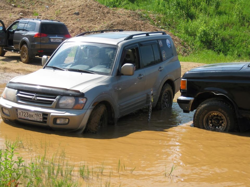 Silver Mitsubishi Pajero/Montero stuck in mud, front view