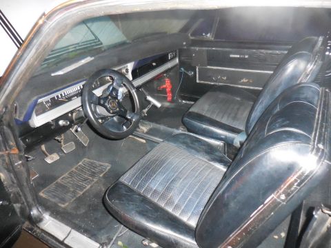 1966 Ford Fairlane - The interior of a 1966 Ford Fairlane shows its dashboard, steering wheel, and front seats.