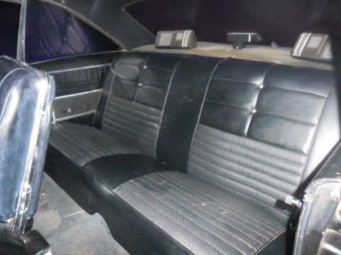 1966 Ford Fairlane - The rear interior of a 1966 Ford Fairlane features black vinyl seats with a patterned insert.