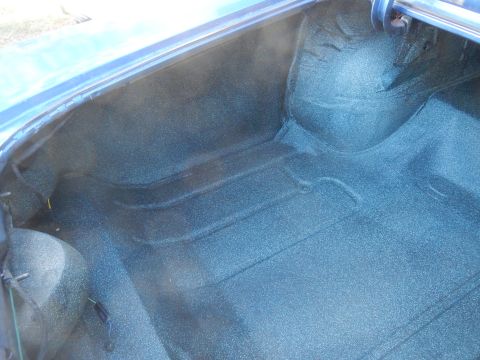 1967 Pontiac GTO - The textured blue carpeting of a vehicle's trunk interior is visible.