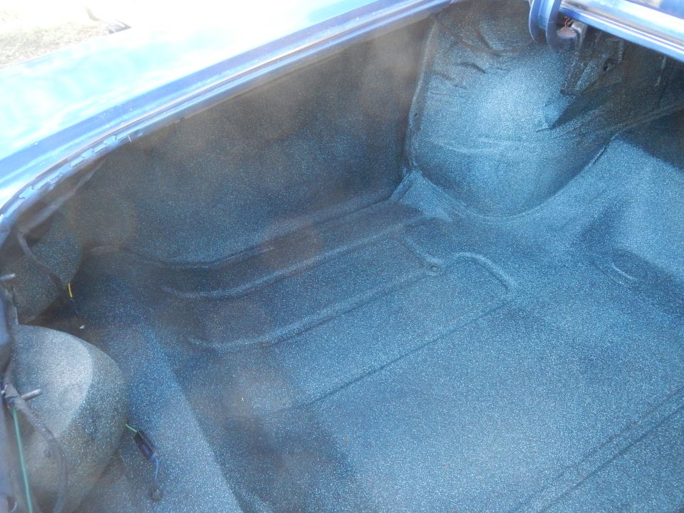 Blue trunk interior with textured carpeting