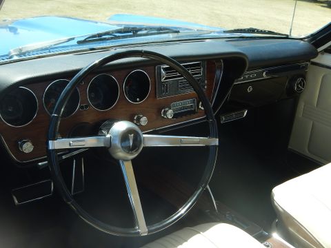 1967 Pontiac GTO - The interior of a 1967 Pontiac GTO shows its classic dashboard and steering wheel.