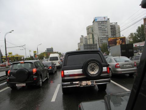 1987 Ford Bronco - Rear view of a 1987 Ford Bronco driving in traffic on a wet day.