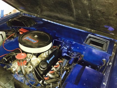 1974 Ford Bronco - Close-up view of a vehicle's engine bay, aftermarket Summit Racing parts.