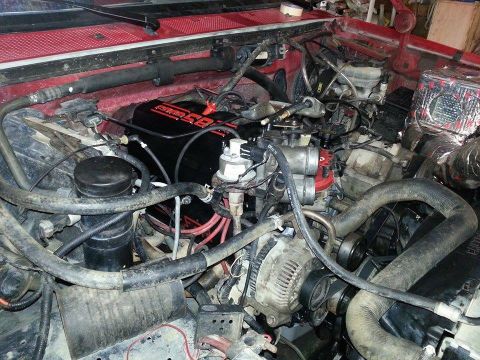 1995 Ford Bronco - Close-up view of an engine bay, showing various components and hoses.