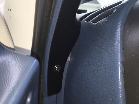 1995 Ford Bronco - A detail shot of the interior trim and a visible screw fastener.