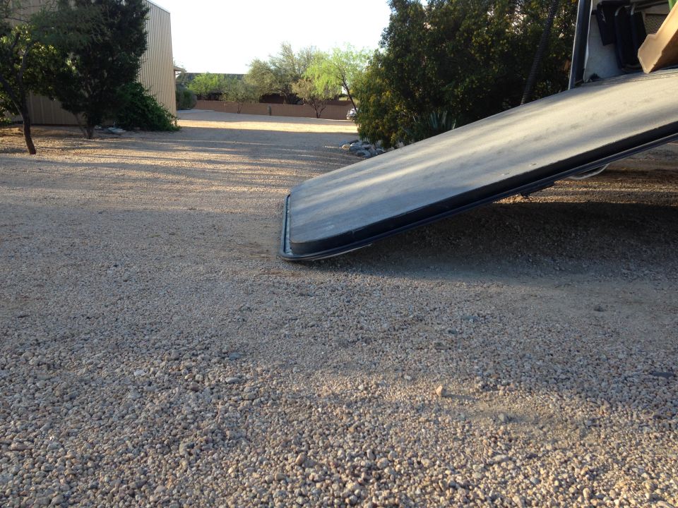 tow truck ramp on gravel driveway