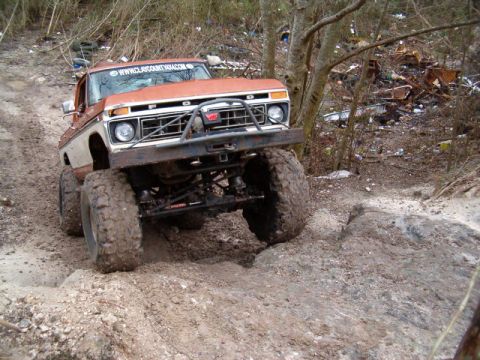 1991 Ford Bronco - Modified Ford truck tackling rough terrain off-road.