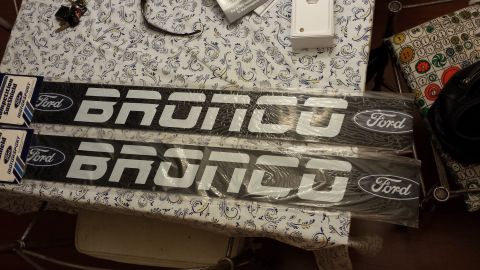 1995 Ford Bronco - Two Ford Bronco sun visors are displayed, each the Bronco name and Ford logo.