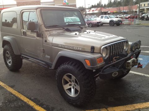 2005 Jeep Wrangler - Tan 2005 Jeep Wrangler Rubicon with aftermarket bumper and lights.