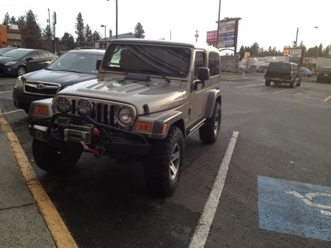 2005 Jeep Wrangler - A Jeep Wrangler Rubicon is parked in a lot, showing its off-road modifications.