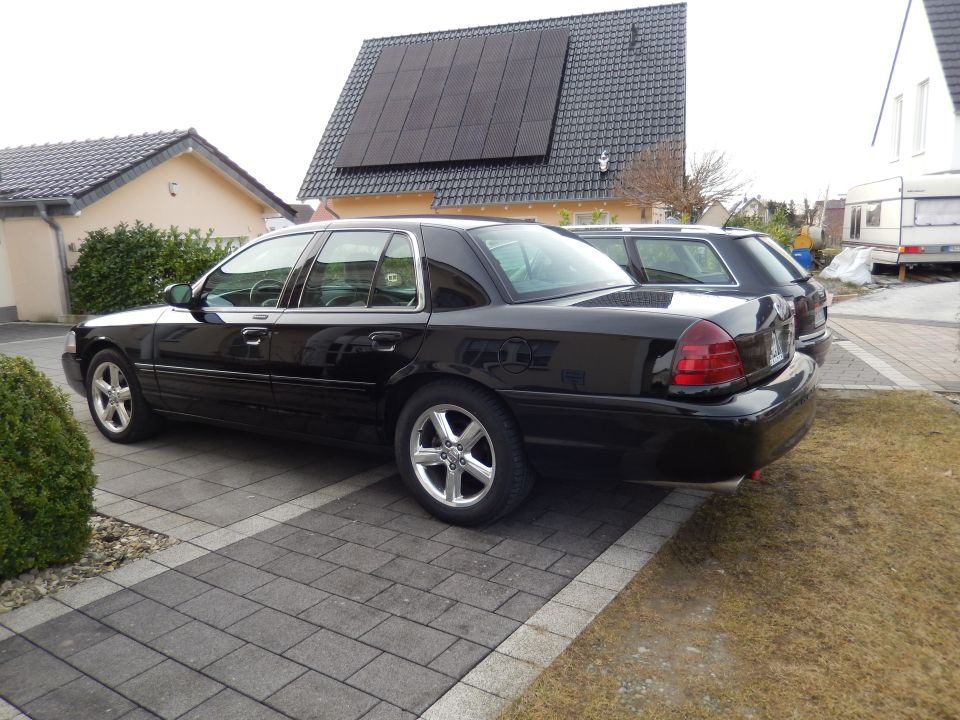2003 Mercury Marauder parked on paved driveway next to another car