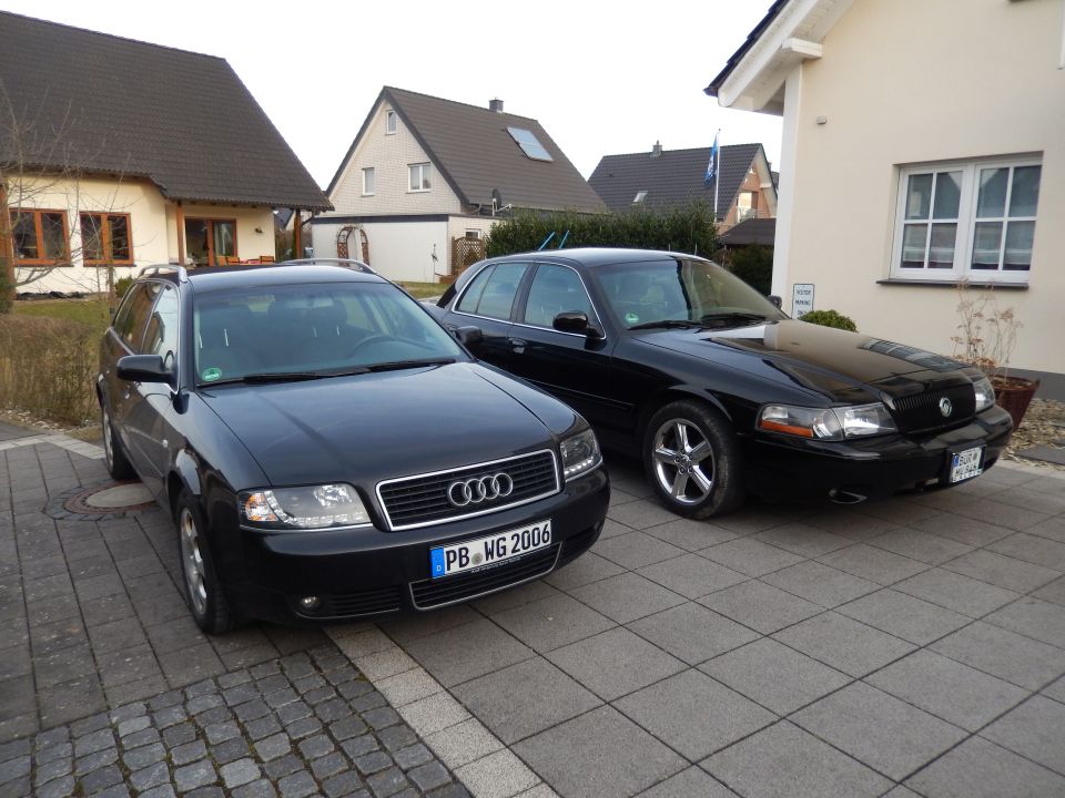 Black 2003 Mercury Marauder parked next to an Audi wagon