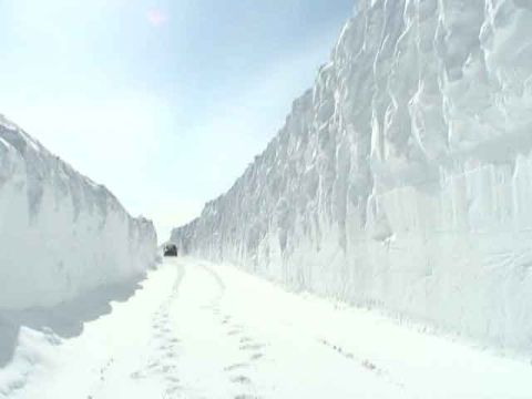1979 Ford Bronco - Driving through a snow-covered road with towering snowbanks.