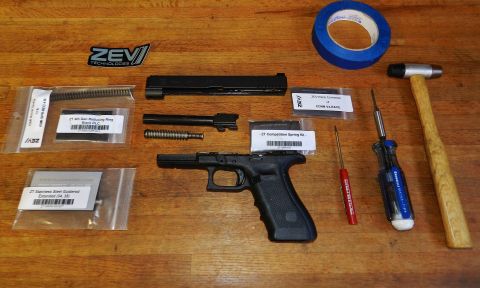1996 Ford Bronco - Disassembled handgun components and tools laid out on a wooden workbench.