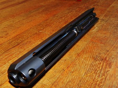 1996 Ford Bronco - Close-up of a gun slide assembly, showing the internal recoil spring mechanism.