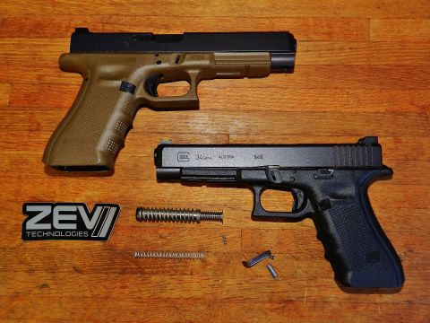 1996 Ford Bronco - Two Glock pistols and their components are arranged on a wooden surface, alongside a ZEV Technologies logo.