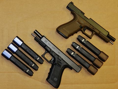 1996 Ford Bronco - Two Glock pistols and several magazines are arranged on a flat surface.