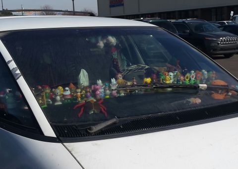 1995 Ford Bronco - Dashboard is decorated with many small figurines and toys.