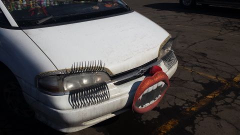 1995 Ford Bronco - This car has been decorated with oversized eyelashes and a novelty mouth accessory on the front.
