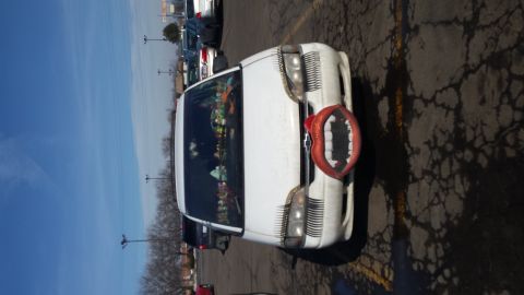 1995 Ford Bronco - This white SUV has a novelty grille resembling teeth and eyelashes on the headlights.
