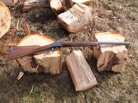 1995 Mercury Grand Marquis - A rifle is displayed on cut logs, with a watermark for SuperMotors.net visible.