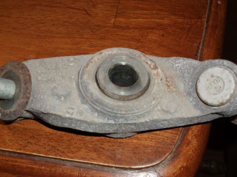 1999 Mercury Grand Marquis - A close-up view of a worn metal automotive part, likely from a vehicle's suspension system.