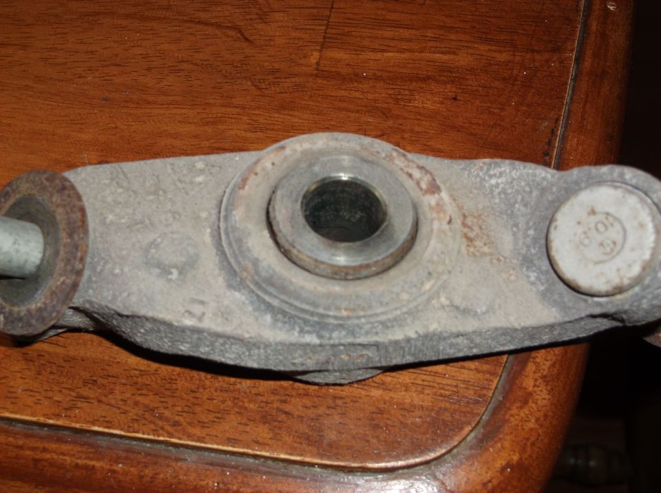 Close-up of a rusty metal suspension component with a bolt head visible