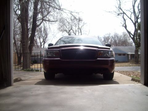 2004 Ford Crown Victoria - Front view of a maroon 2004 Ford Crown Victoria parked in a garage.