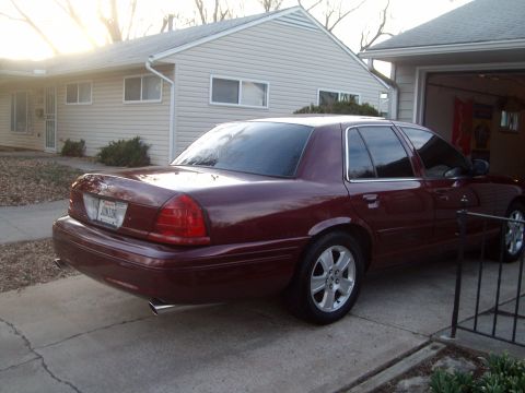 2004 Ford Crown Victoria - Maroon 2004 Ford Crown Victoria parked in driveway next to a garage.