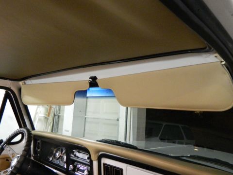 1979 Ford Bronco - The tan interior of a 1978 Ford Bronco shows its dashboard and sun visors.