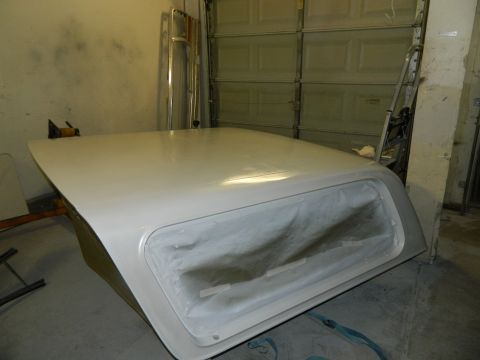 1979 Ford Bronco - A white Ford Bronco hardtop is shown in a garage, with its window covered for protection.
