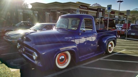1979 Ford Bronco - A custom purple 1953 Ford F-100 pickup truck is parked at a car show.