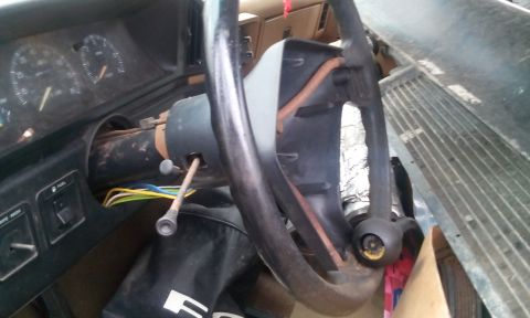 1988 Ford F-150 - The interior of a 1988 Ford F-150 shows the steering column and dashboard gauges, with a portion of the radiator visible.