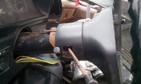1988 Ford F-150 - Interior view of a vehicle's steering column with exposed wiring and a removed ignition cylinder.
