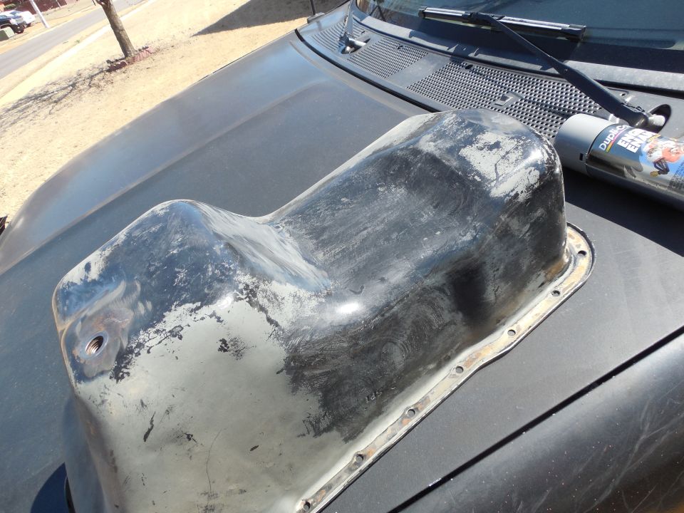3 days ago there was ice on the ground; today, I'm sweating in short sleeves & long jeans.  But it's warm enough to finish washing the engine parts.  This was almost completely gray before it was washed with hot water & degreaser.  A nylon brush removed most of the paint that's smeared, and today I'm going to wire-brush it before hosing it down inside & out with DupliColor Engine Gray.