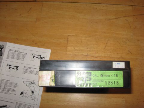 1976 Dodge Power Ram - Ammunition box and firearm instructions are laid out on a wooden surface.