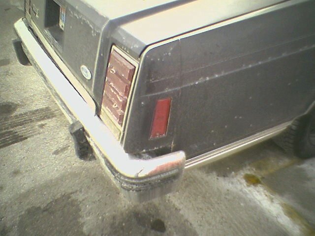 Rear bumper and taillight of a dark-colored car