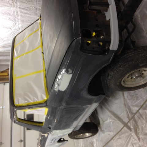 1992 Ford Bronco - A 1992 Ford Bronco is undergoing bodywork, with windows taped off for protection.