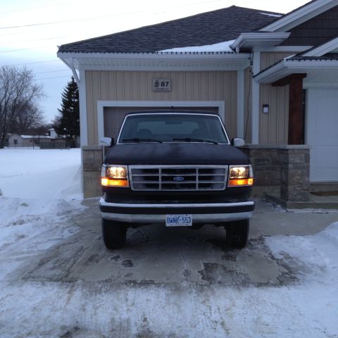 1992 Ford Bronco - Front view of a 1992 Ford Bronco parked in a driveway with snow on the ground.